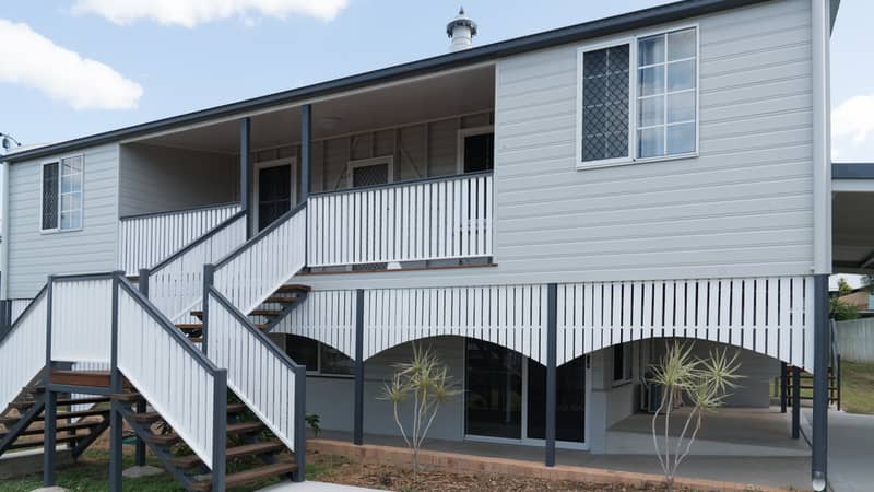 Old Queenslander style home after renovation and repaint, new double stairs