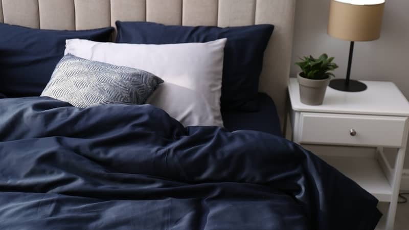 bed with pillows and blue doona