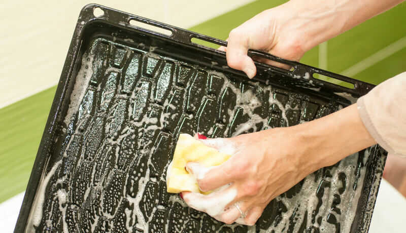 Wiping down oven tray