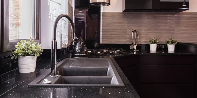 Closeup of countertop and granite sink in brocade kitchen