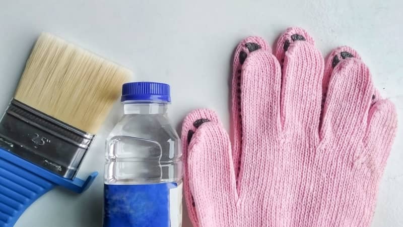 paint brush, paint thinner, and pink gloves