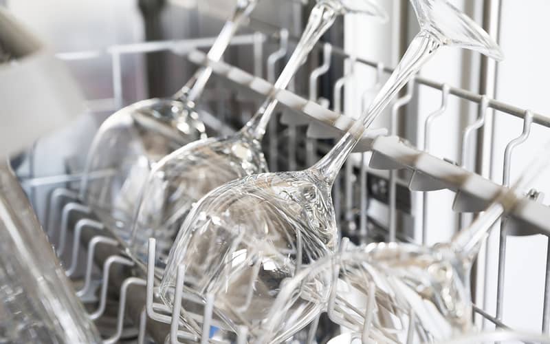 Closeup of stainless glasses for wine after cleaning in a dishwasher.