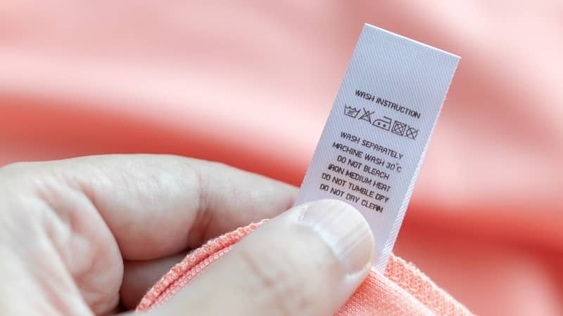 woman checking the care label on clothes