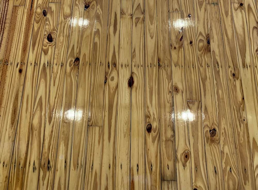 Polished timber floors reflecting ceiling lights