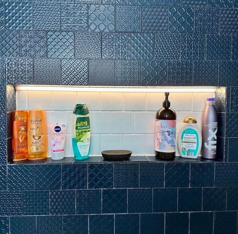 clean shower tiles and shower shelf