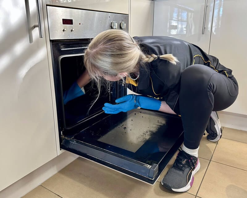 cleaning the bottom of the oven