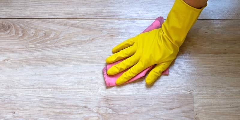 cleaning the flooring with a damp cloth