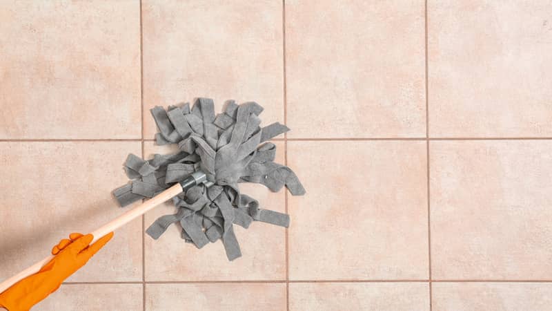 cleaning tiles with a mop