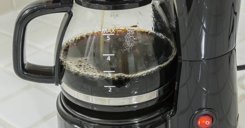 Coffee maker pot filling close up