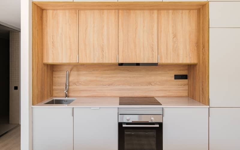 Laminate cabinets over the stove in a minimal kitchen