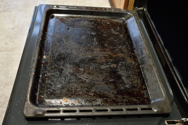 Dirty oven tray needing to be cleaned