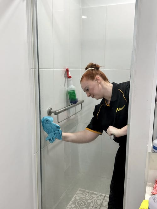 drying the shower glass with microfibre cloth