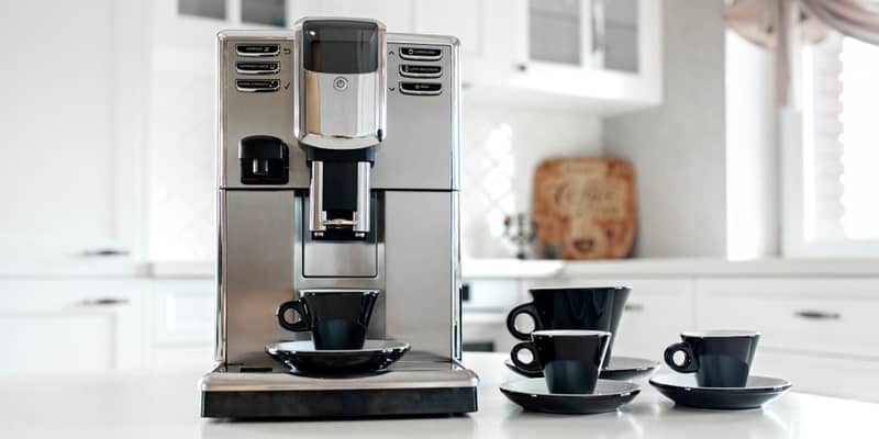 Coffee machine with cups for espresso on the kitchen table. 