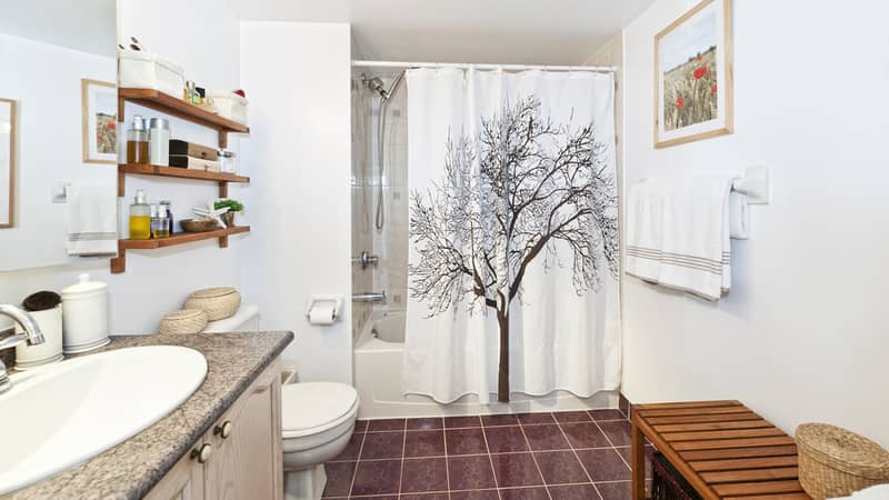 hanging shower curtain in the bathroom