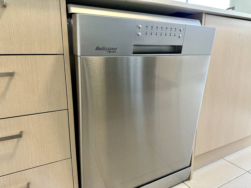 Stainless steel dishwasher integrated into a kitchen cabinet setup