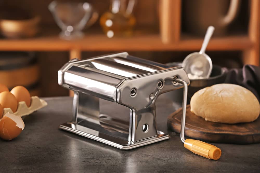 Metal pasta maker on kitchen table