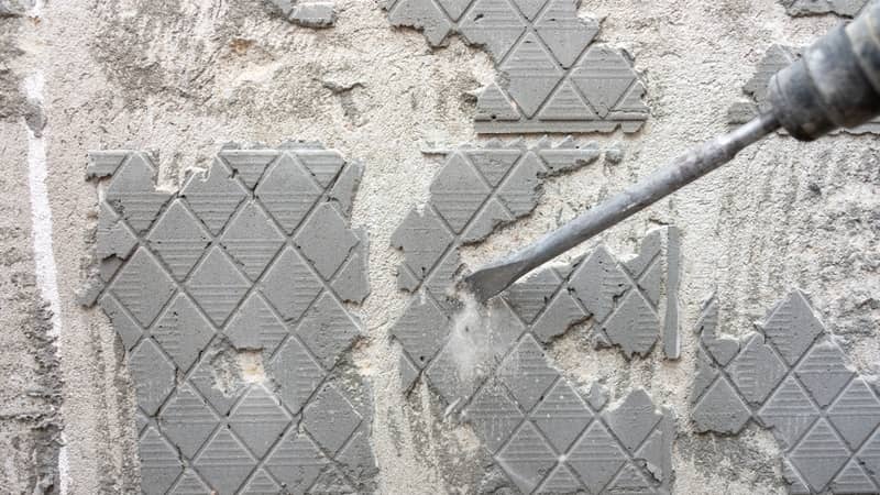 Removing old tile adhesive from the wall with a perforator