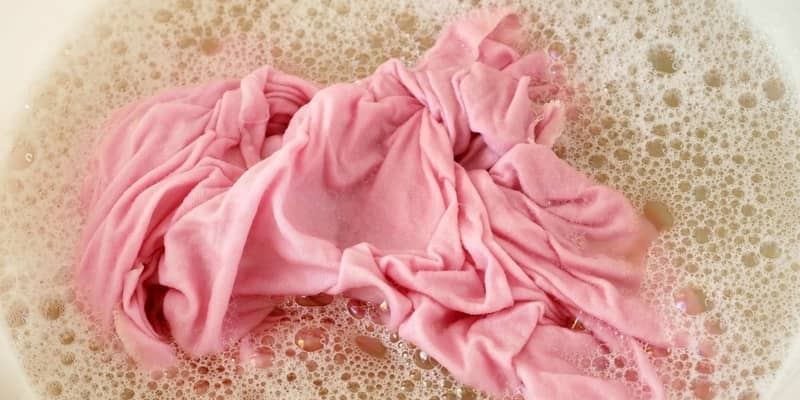 clothes soaking in a basin full of water and detergent