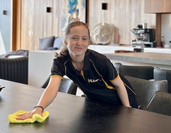 local cleaner smiling while cleaning