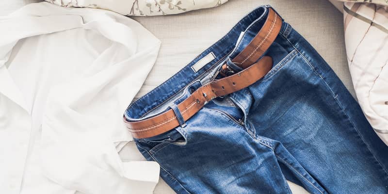 jeans laid on bed in the morning light with white shirt