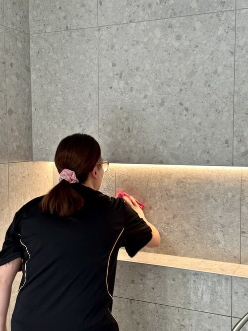 Kirsten cleaning shower tiles