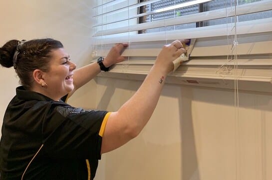 NDIS-cleaner-wiping-blinds