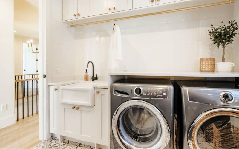 large laundry room with dark stainless front load washer and dryer