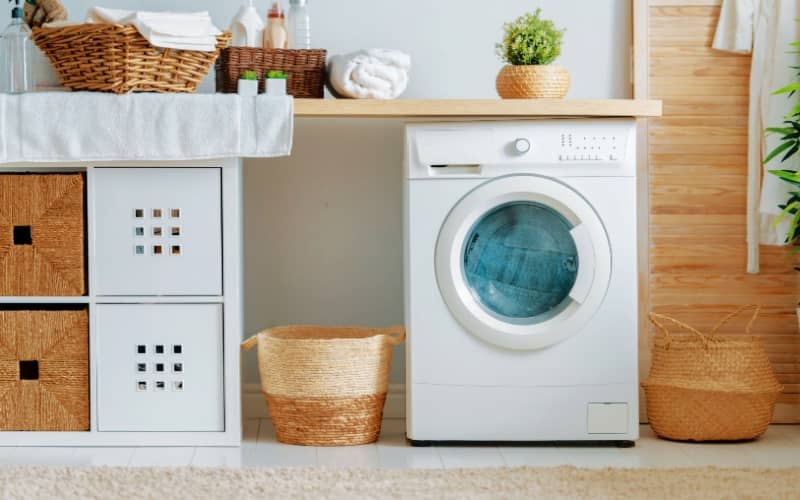 laundry room with front load washing machine