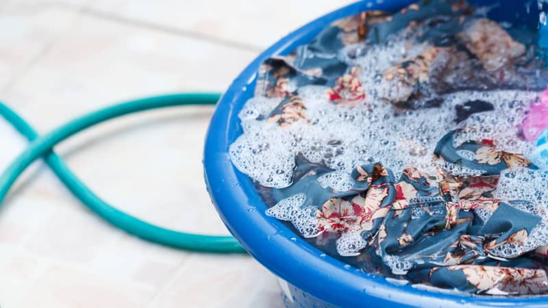 Clothes are soaked in basin to prepare for washing