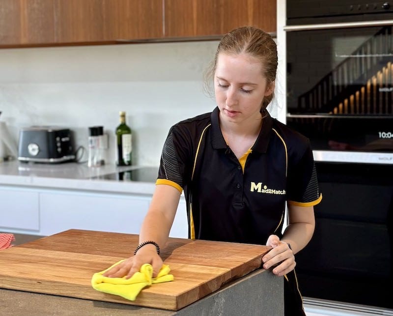 Maid2Match cleaner wiping down a cutting board