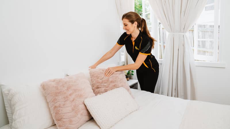 professional cleaner cleaning the bedroom