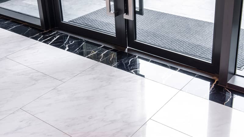 Marble floor tiles near the glass door.