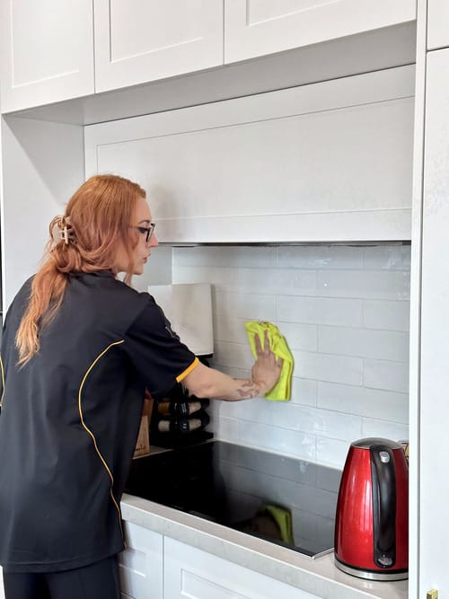 Maria cleaning kitchen tile grout