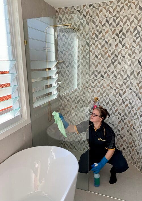 Mihaela cleaning shower glass