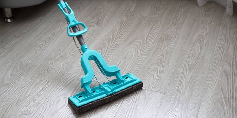 blue mop on laminate flooring in the room