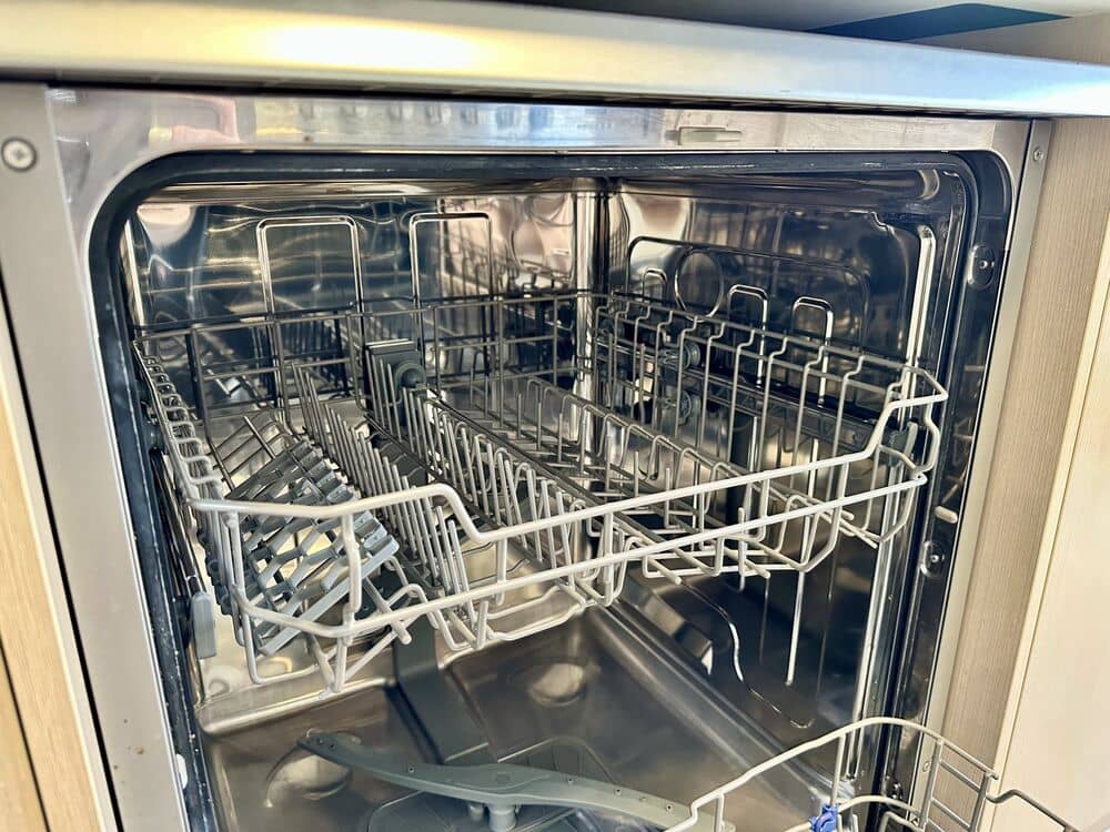 Stainless steel dishwasher interior with empty racks