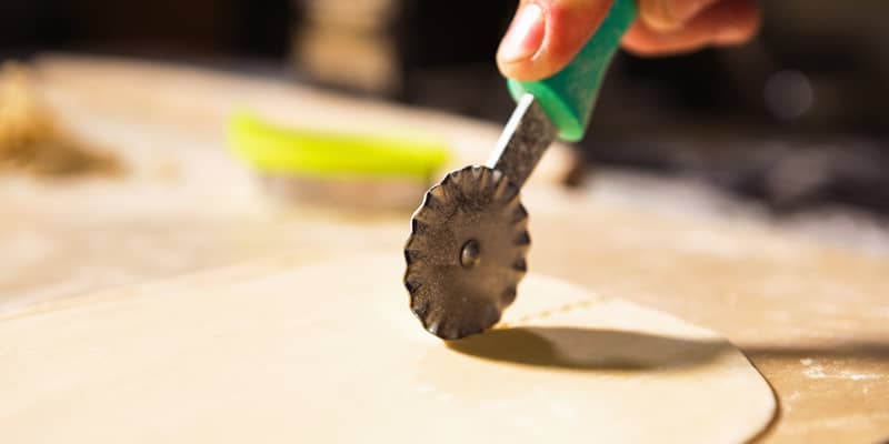 Pastry cutter knife cutting thin dough for ravioli