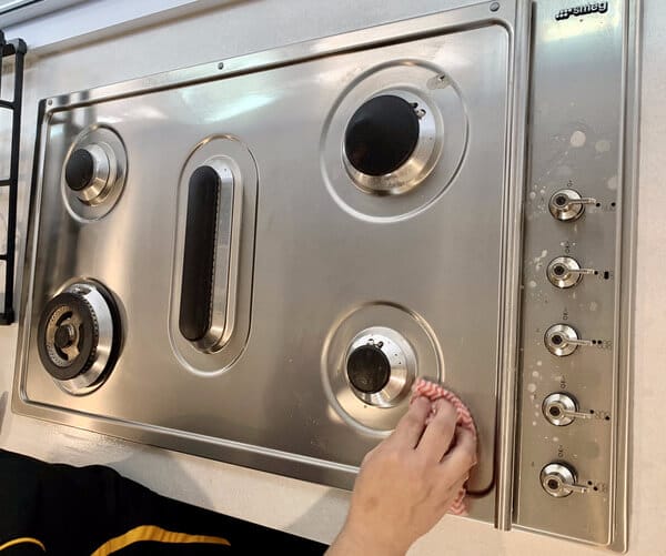 polishing the stainless steel cooktop