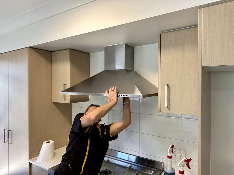 professional cleaner checking the range hood filter