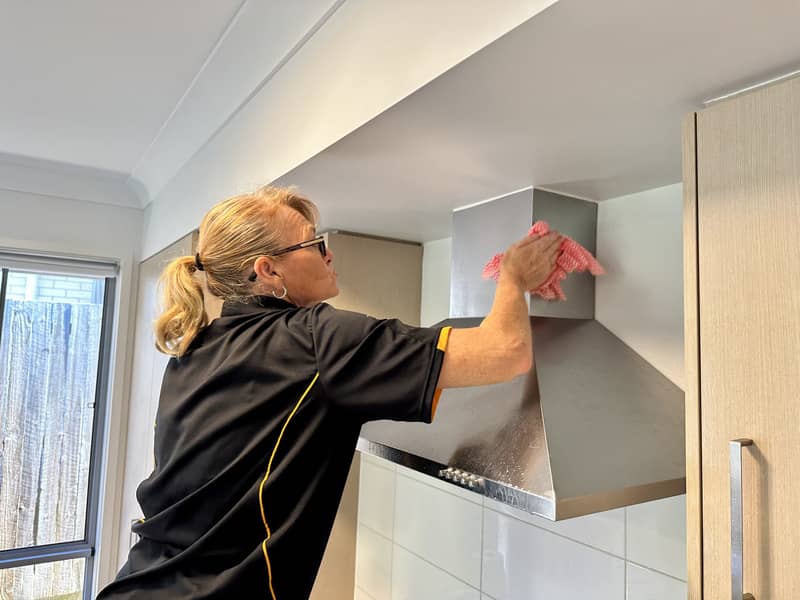 professional cleaner cleaning the rangehood