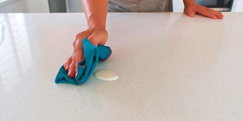 Cleaning Caesarstone benchtop - selective focus