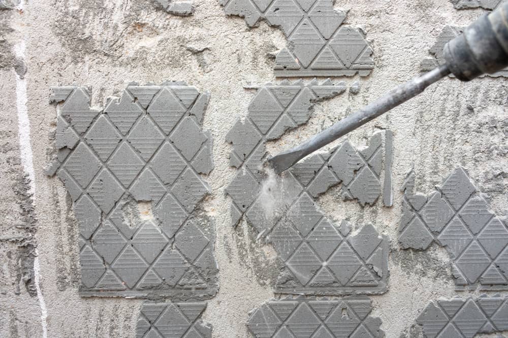 Removing old tile adhesive from the wall with a perforator