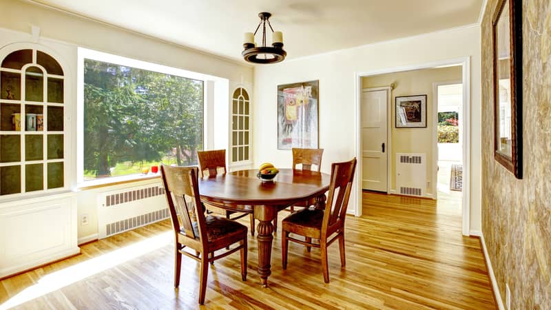 Bright dining are with window and built-in cabinets . Wooden round dining table with chairs