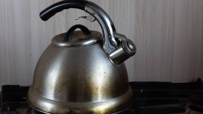 Dirty stainless steel kettle with stains