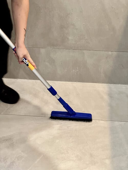 scrubber brush on shower grout