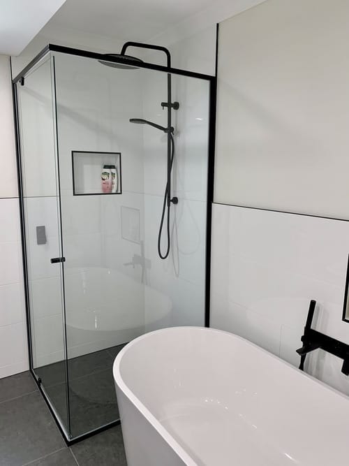 shower with glass door and walls