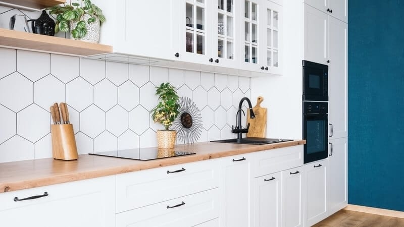 Side view of modern kitchen interior design with blue wall