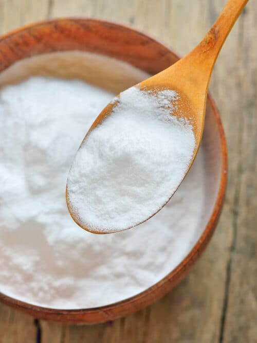 Close-up of Spoon of baking soda over bowl of baking soda