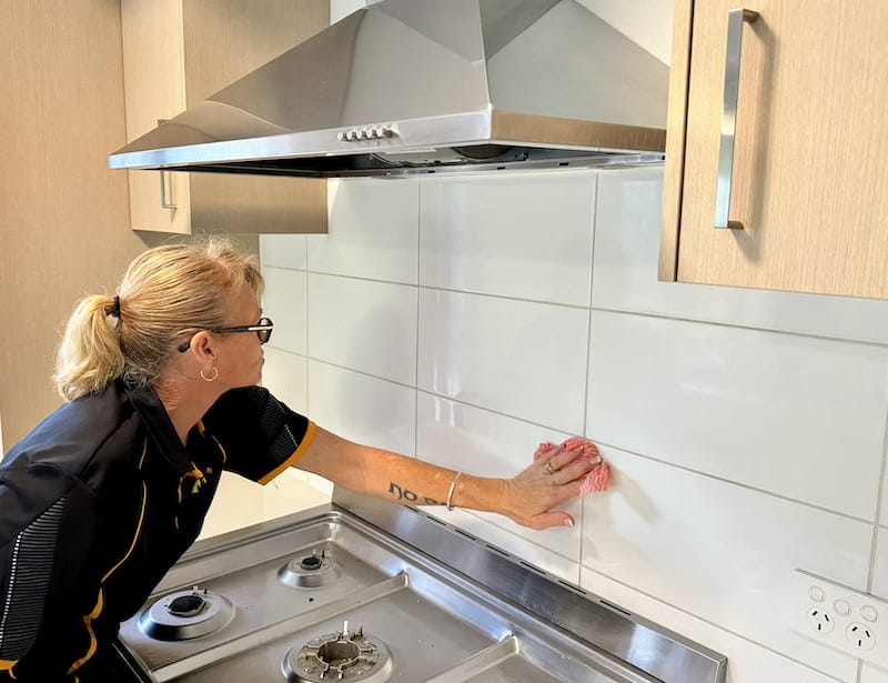 spring cleaning the kitchen, wiping the backsplash