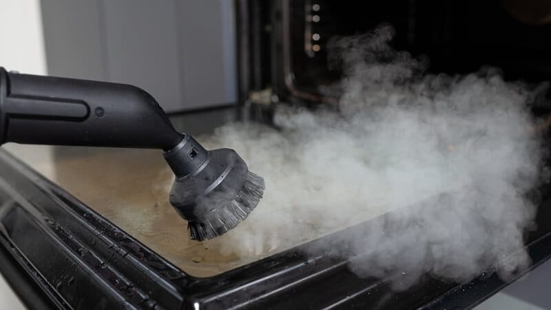 using a steam cleaner to clean the oven